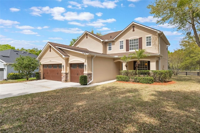 30439 Gidran Ter, Mount Dora, FL 32757 - view of front of home featuring a front yard, concrete driveway, stucco siding, an attached garage, and fence