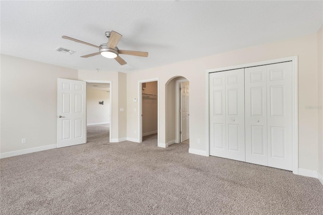 30439 Gidran Ter, Mount Dora, FL 32757 - unfurnished bedroom featuring multiple closets, visible vents, carpet, baseboards, and arched walkways