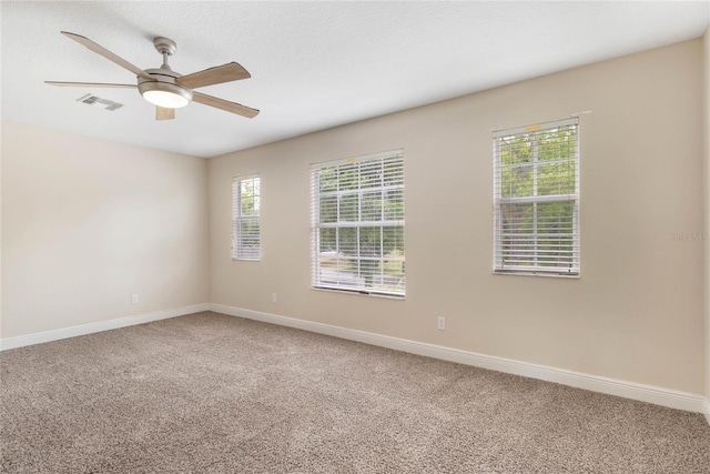 30439 Gidran Ter, Mount Dora, FL 32757 - unfurnished room with light colored carpet, visible vents, baseboards, and a ceiling fan
