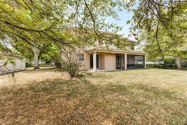 30439 Gidran Ter, Mount Dora, FL 32757 - rear view of house featuring stucco siding and a yard
