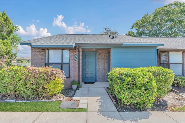 2435 King Oak Ln, Saint Cloud, FL 34769 - view of front facade with brick siding and roof with shingles