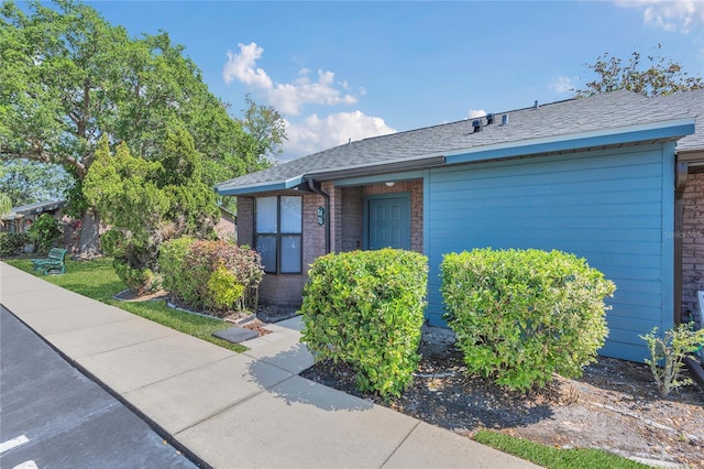 2435 King Oak Ln, Saint Cloud, FL 34769 - view of front of property with brick siding and a shingled roof