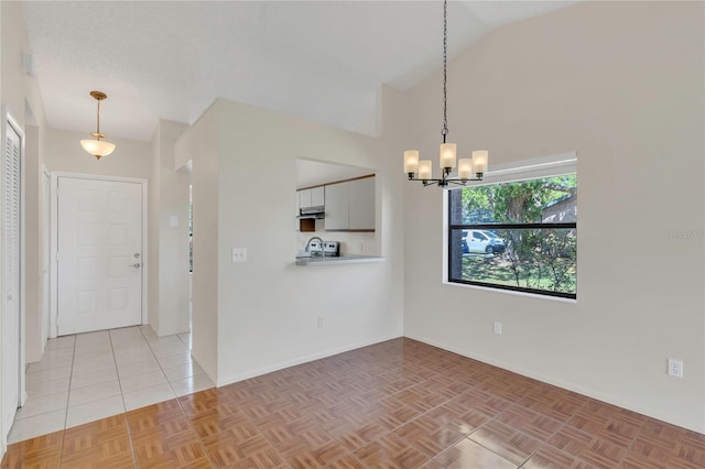 2435 King Oak Ln, Saint Cloud, FL 34769 - empty room featuring vaulted ceiling, light tile patterned floors, and a chandelier