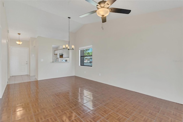 2435 King Oak Ln, Saint Cloud, FL 34769 - unfurnished living room featuring ceiling fan with notable chandelier and high vaulted ceiling