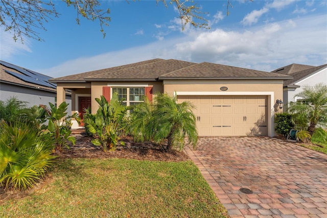 ranch-style home featuring decorative driveway, a garage, a shingled roof, and stucco siding