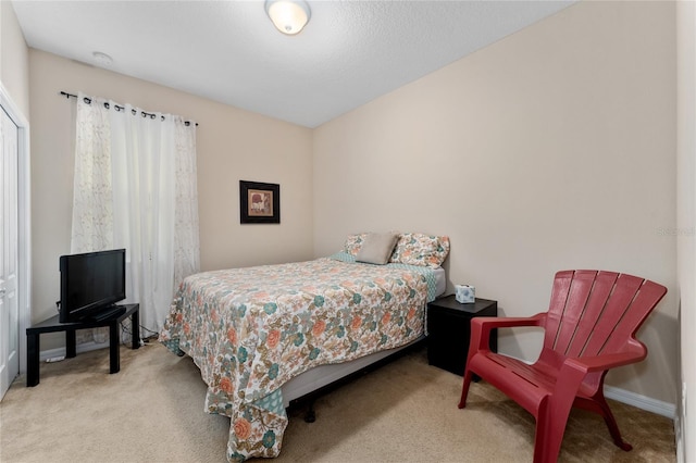 bedroom with baseboards and carpet