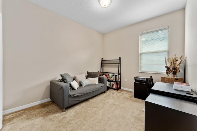 bedroom featuring light carpet and baseboards
