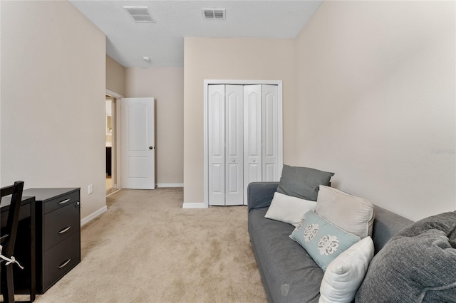 interior space featuring light carpet, visible vents, and baseboards