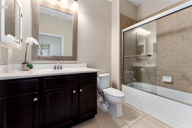 full bath with tile patterned flooring, toilet, vanity, and enclosed tub / shower combo