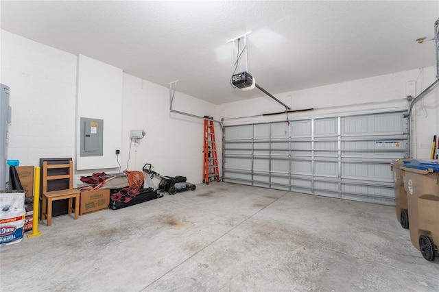 garage with electric panel, a garage door opener, and concrete block wall