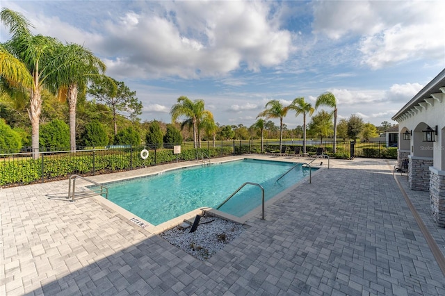 pool featuring a patio area and fence