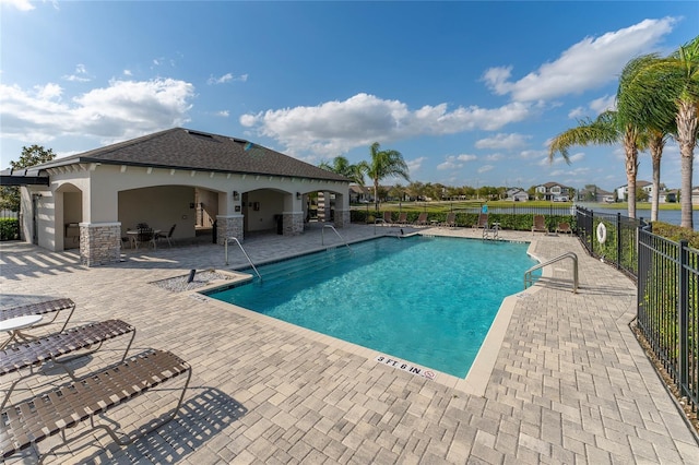 pool featuring a patio and fence