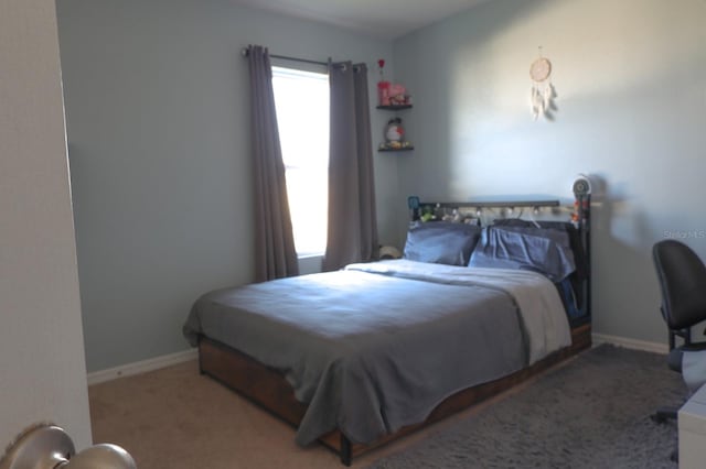 bedroom featuring baseboards and carpet floors