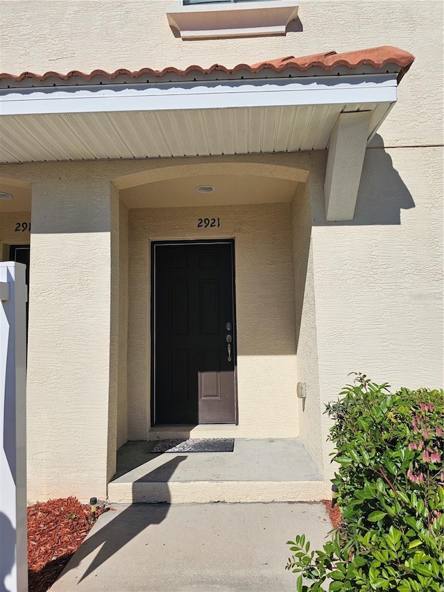 2921 Puerta Del Sol Blvd, Kissimmee, FL 34744 - view of exterior entry featuring stucco siding