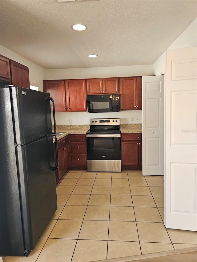 2921 Puerta Del Sol Blvd, Kissimmee, FL 34744 - kitchen with black appliances, a textured ceiling, recessed lighting, light countertops, and light tile patterned floors