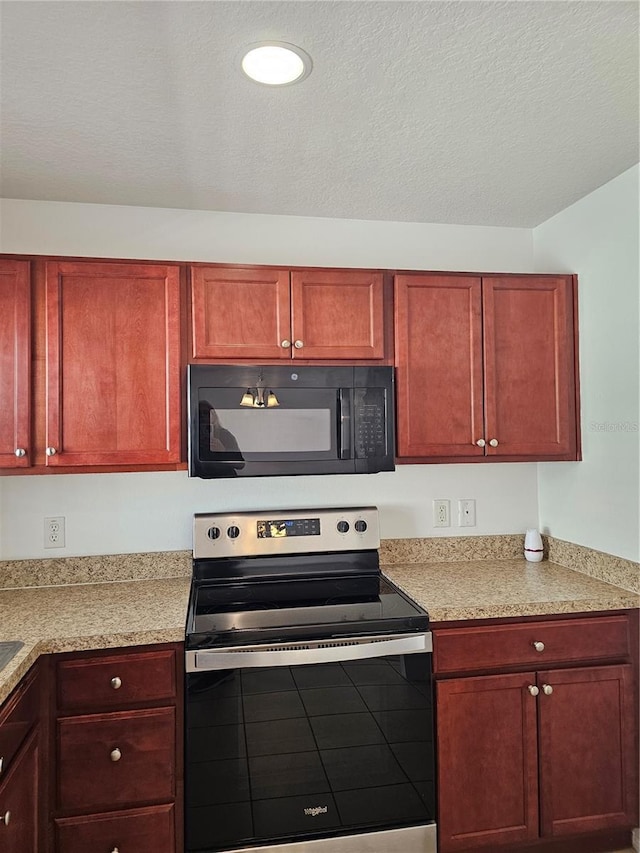 2921 Puerta Del Sol Blvd, Kissimmee, FL 34744 - kitchen with stainless steel range with electric stovetop, black microwave, and reddish brown cabinets