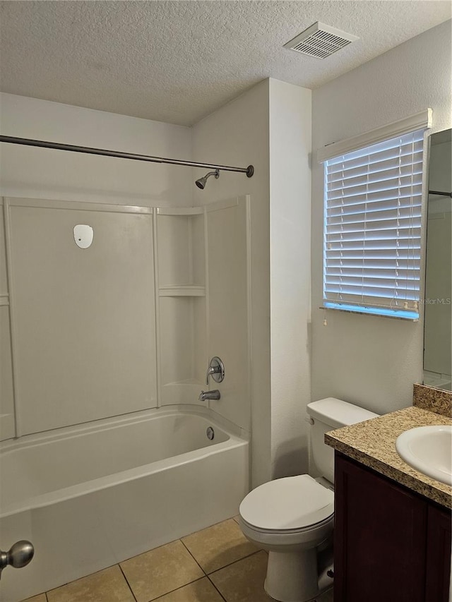 2921 Puerta Del Sol Blvd, Kissimmee, FL 34744 - full bathroom featuring visible vents, vanity, tile patterned floors, a textured ceiling, and  shower combination