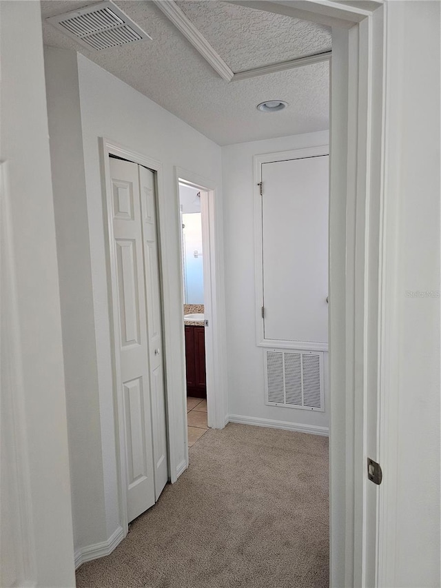 2921 Puerta Del Sol Blvd, Kissimmee, FL 34744 - hall with visible vents, light carpet, a textured ceiling, and baseboards