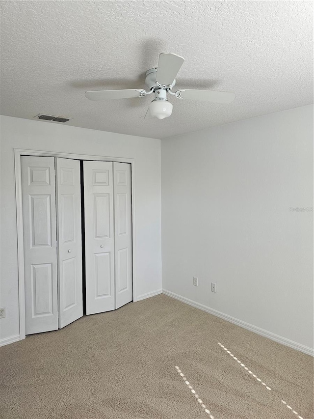 2921 Puerta Del Sol Blvd, Kissimmee, FL 34744 - unfurnished bedroom featuring a ceiling fan, baseboards, visible vents, a closet, and carpet flooring