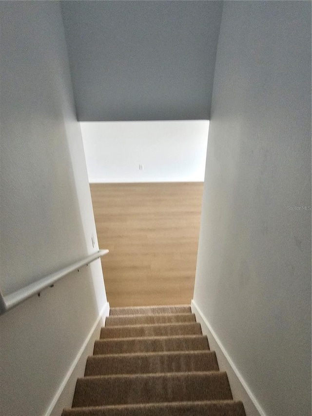 2921 Puerta Del Sol Blvd, Kissimmee, FL 34744 - staircase with baseboards and wood finished floors
