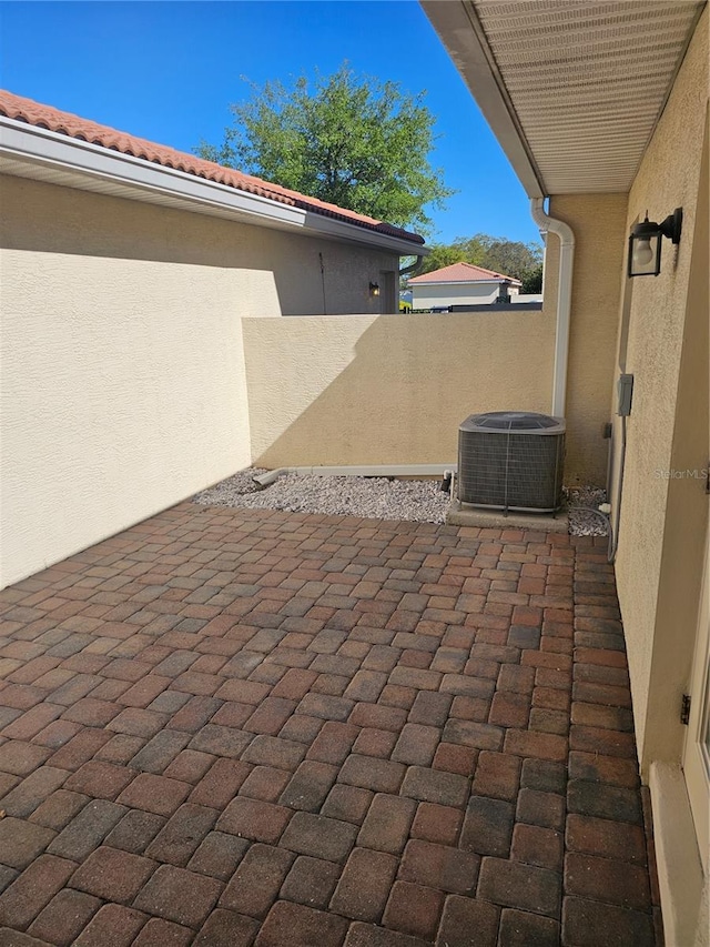 2921 Puerta Del Sol Blvd, Kissimmee, FL 34744 - view of patio featuring cooling unit and fence