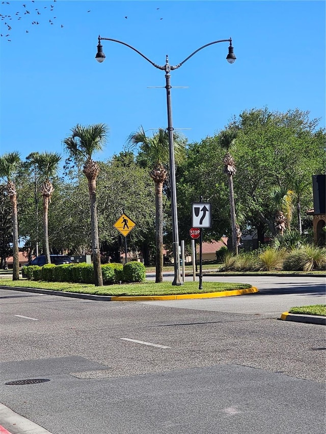 2921 Puerta Del Sol Blvd, Kissimmee, FL 34744 - view of road featuring traffic signs, curbs, and street lighting