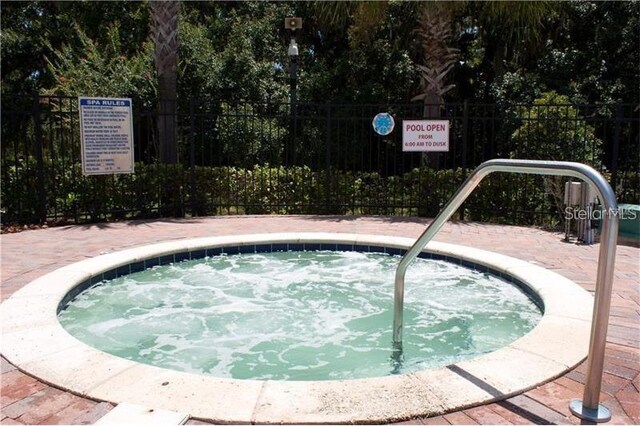 2921 Puerta Del Sol Blvd, Kissimmee, FL 34744 - view of swimming pool featuring a community hot tub and fence