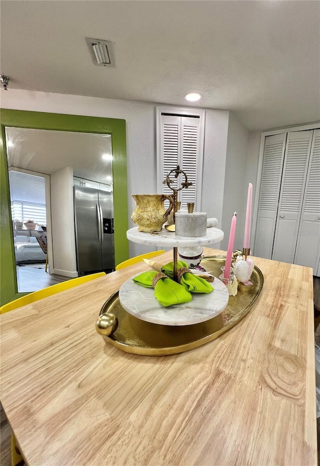 dining space with wood finished floors