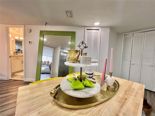 dining area with recessed lighting, baseboards, and wood finished floors
