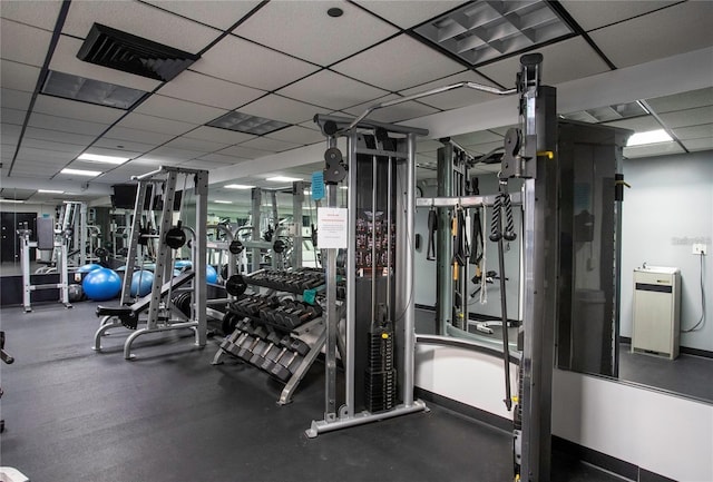 exercise room with a paneled ceiling