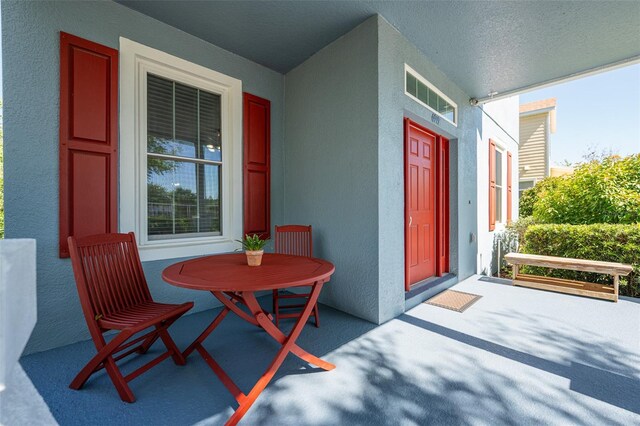 exterior space featuring stucco siding and covered porch