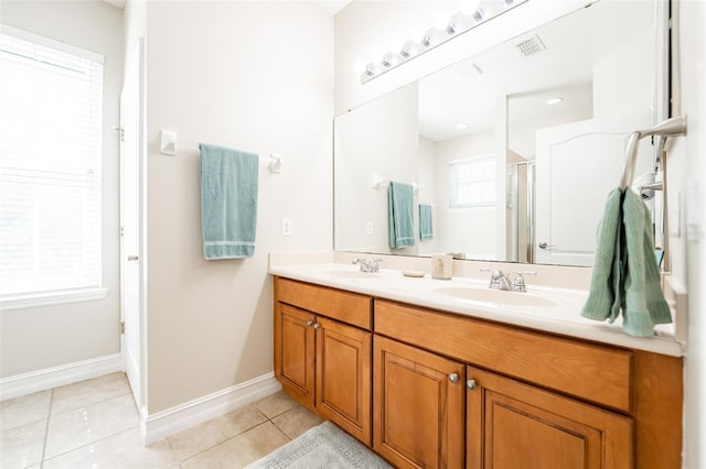 full bath with a stall shower, visible vents, tile patterned flooring, and a sink