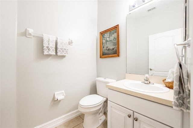 half bath featuring tile patterned floors, toilet, vanity, baseboards, and visible vents
