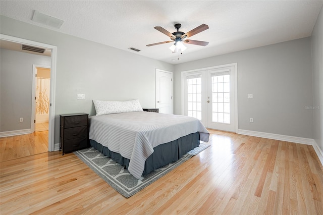 bedroom featuring baseboards, visible vents, wood finished floors, and access to outside