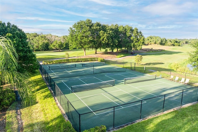 view of sport court featuring a yard and fence