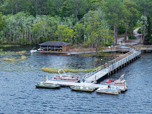view of dock with a water view and a view of trees