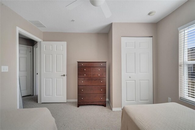 4561 Yellowgold Rd E Unit 107, Kissimmee, FL 34746 - bedroom featuring baseboards, visible vents, a ceiling fan, light carpet, and a closet