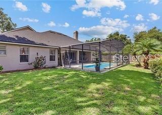 3637 Rothbury Dr, Belle Isle, FL 32812 - back of property featuring a fenced in pool, a lanai, and a yard