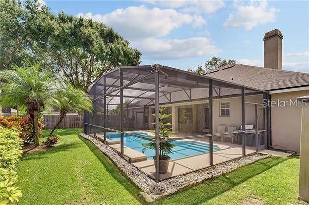 3637 Rothbury Dr, Belle Isle, FL 32812 - view of swimming pool featuring fence, a fenced in pool, a patio, a yard, and glass enclosure
