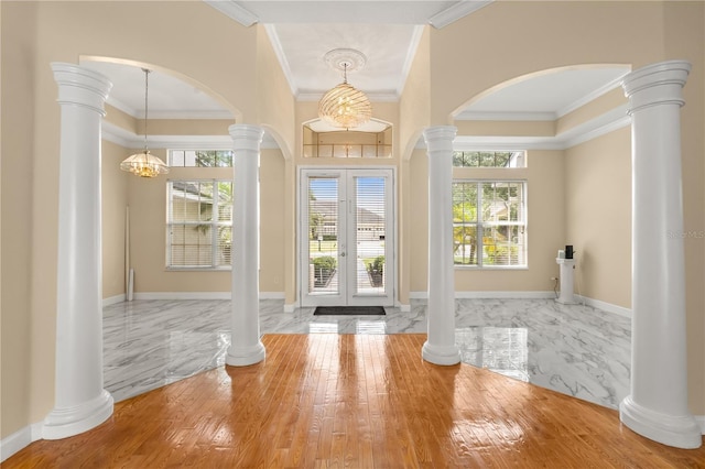3637 Rothbury Dr, Belle Isle, FL 32812 - entrance foyer featuring french doors, arched walkways, baseboards, ornamental molding, and ornate columns