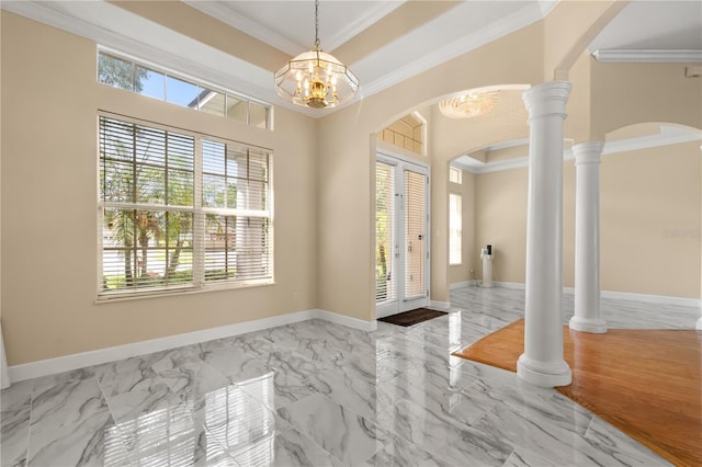 3637 Rothbury Dr, Belle Isle, FL 32812 - entrance foyer with arched walkways, marble finish floor, a chandelier, and ornamental molding
