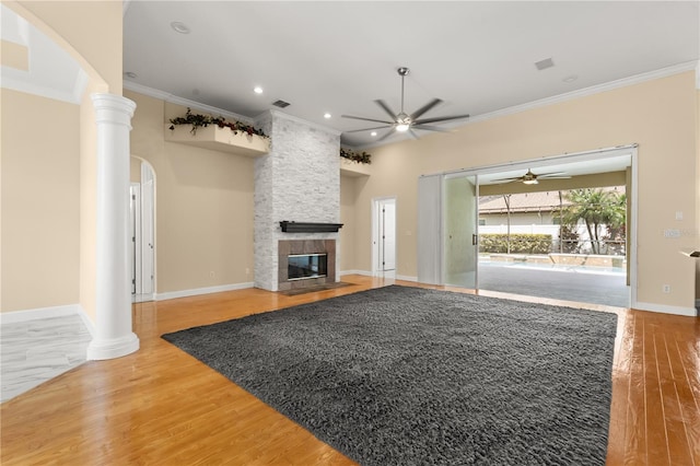 3637 Rothbury Dr, Belle Isle, FL 32812 - unfurnished living room with crown molding, arched walkways, a fireplace, and a ceiling fan
