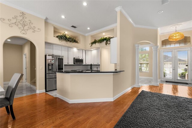 3637 Rothbury Dr, Belle Isle, FL 32812 - kitchen with arched walkways, ornamental molding, stainless steel appliances, and ornate columns