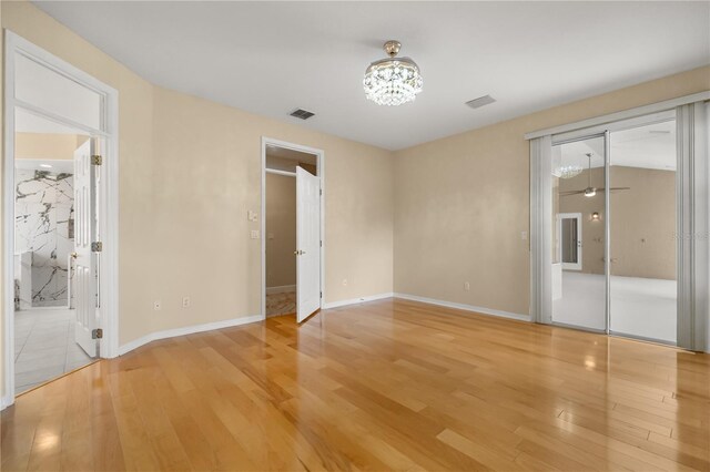 3637 Rothbury Dr, Belle Isle, FL 32812 - unfurnished bedroom featuring an inviting chandelier, visible vents, and light wood-type flooring