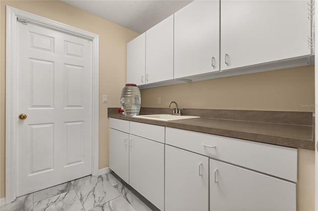 3637 Rothbury Dr, Belle Isle, FL 32812 - laundry area with baseboards, a sink, and marble finish floor