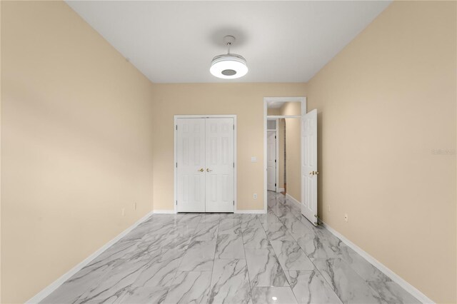 3637 Rothbury Dr, Belle Isle, FL 32812 - unfurnished bedroom with a closet, marble finish floor, and baseboards