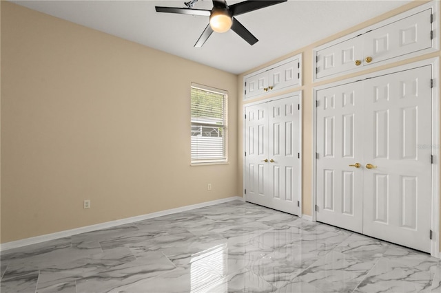 3637 Rothbury Dr, Belle Isle, FL 32812 - unfurnished bedroom with baseboards, marble finish floor, multiple closets, and ceiling fan