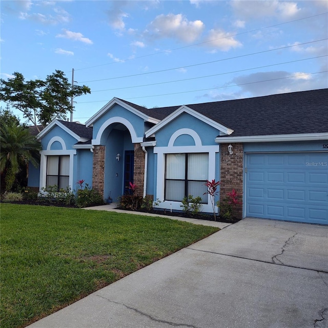 12966 Broakfield Cir, Orlando, FL 32837 - ranch-style home featuring concrete driveway, roof with shingles, stucco siding, a front yard, and a garage