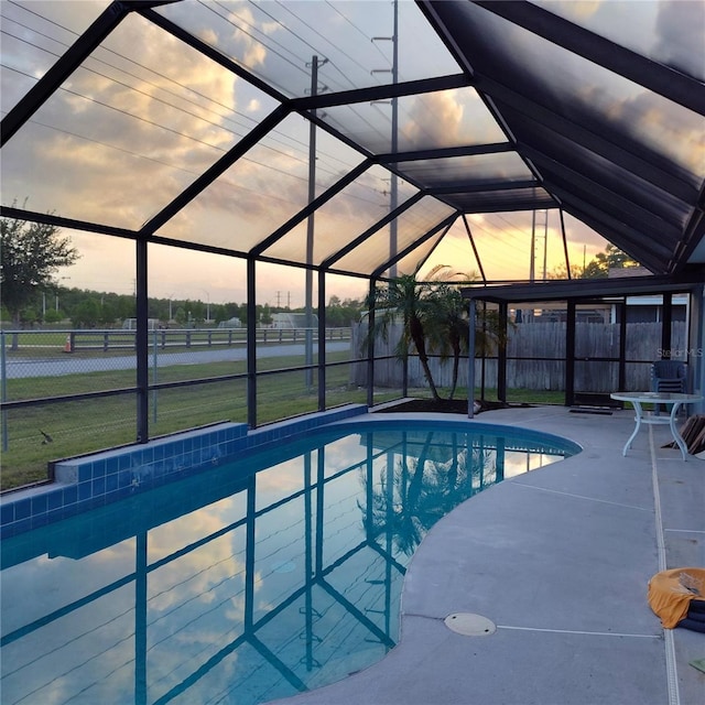12966 Broakfield Cir, Orlando, FL 32837 - outdoor pool featuring a patio area, fence, a lawn, and glass enclosure