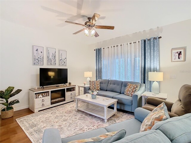 501 Heartwell Dr, Poinciana, FL 34759 - living room featuring baseboards, wood finished floors, and a ceiling fan